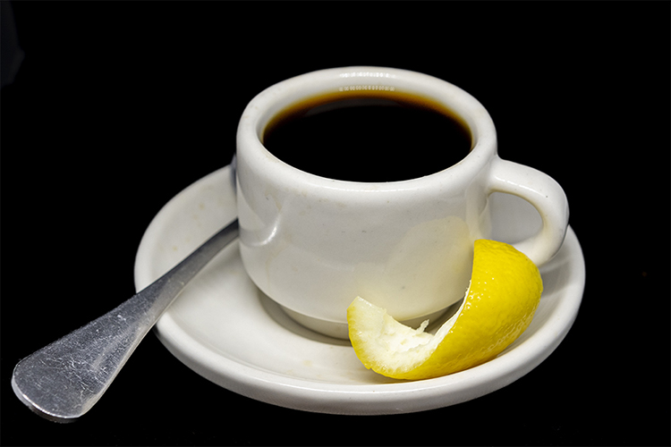 espresso cafe bustelo espresso garnished with a lemon twist price four